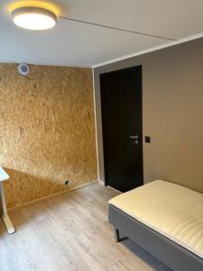 a room with a bed and a black door at Wergelandsvegen 40B in Stjoerdal