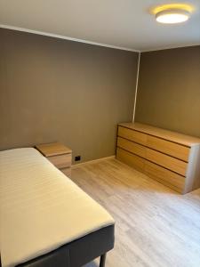 an empty room with a bed and wooden cabinets at Wergelandsvegen 40B in Stjoerdal