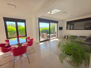 a living room with red chairs and a table at Sea Melody in Lopar