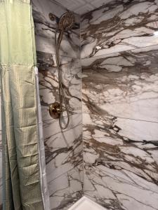 a shower in a bathroom with a marble wall at Raystown Country Lodge in Huntingdon +64 photos