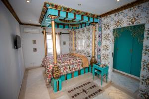 a bedroom with a bed with a canopy at Milles et une Nuits Sidi Bou in Dar Salah Bey