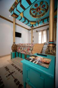 a living room with a couch and a table at Milles et une Nuits Sidi Bou in Dar Salah Bey