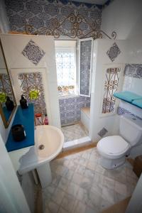 a bathroom with a toilet and a sink and a shower at Milles et une Nuits Sidi Bou in Dar Salah Bey