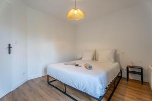 a bedroom with a bed with a cross on the wall at Le Saphir By Clem in Pélussin