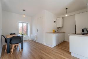 a kitchen with a desk and a table in a room at Le Saphir By Clem in Pélussin