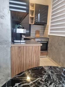 a kitchen with a counter top and a stove at GOLDEN APARTMENT- Militari Residence Bucharest in Dudu