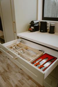 an open drawer in a kitchen with utensils at Nitaure Glamping in Viļums