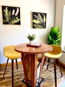 a wooden table and two yellow chairs in a room at Lake Avenue Lofts- Cascade in Duluth