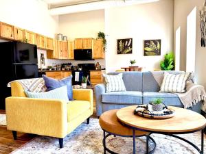 a living room with two couches and a table at Lake Avenue Lofts- Cascade in Duluth