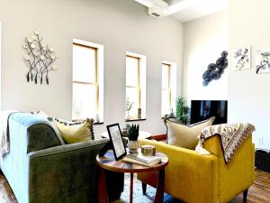 a living room with two couches and a table at Lake Avenue Lofts- Cascade in Duluth +6 photos