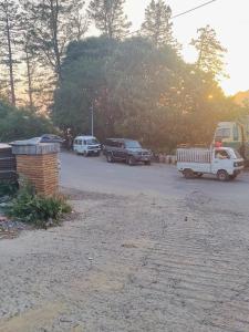 a group of cars parked in a parking lot at Snow Stones in Khaira Gali +4 photos