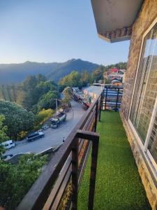 a balcony of a building with a view of a street at Snow Stones in Khaira Gali