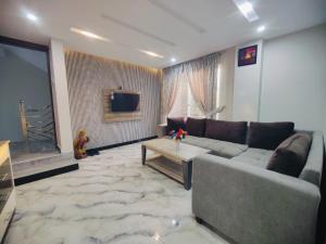 a living room with a couch and a coffee table at Snow Stones in Khaira Gali