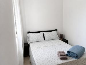a bedroom with a bed with two towels on it at Lica in Espargos