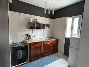 a kitchen with wooden cabinets and a stove top oven at Lica in Espargos