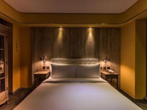 Voodi või voodid majutusasutuse inhouse Hotel toas