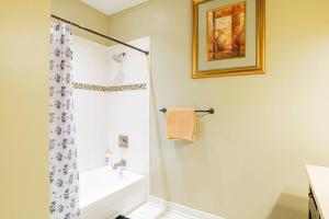 a bathroom with a shower and a white tub at Downtown Mobile Gem Steps from Cruise & Train Terminals in Mobile +4 photos