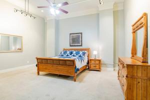 a bedroom with a bed and a dresser and a ceiling fan at Downtown Mobile Gem Steps from Cruise & Train Terminals in Mobile