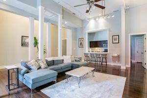 a living room with a blue couch and a table at Downtown Mobile Gem Steps from Cruise & Train Terminals in Mobile