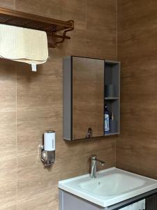 a bathroom with a sink and a mirror at Nady Apartment in Dodoma +65 photos