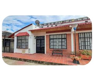 a brick house with a bench in front of it at Casa amoblada in Yopal