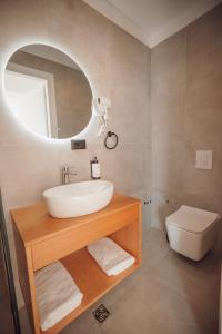 a bathroom with a sink and a toilet at IONEO Dhermi in Dhërmi