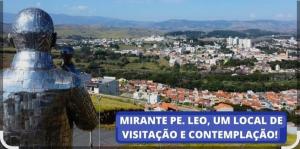 a statue of a man looking out over a city at Lírio-da-paz in Cachoeira Paulista