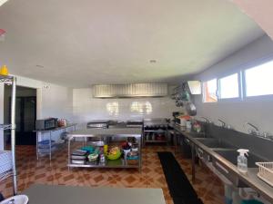 a large kitchen with stainless steel counters and stainless steel appliances at Hotel Ensueño del Bosque Valle de Bravo in Valle de Bravo