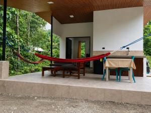 a hammock on the patio of a house at Casa de Ale in Tena
