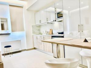 a kitchen with white cabinets and a counter top at The Corfu Urban Stays in Ágios Rókkos +45 photos