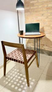a table with a laptop sitting on top of a bench at Studio Jael Rivera in San Antonio