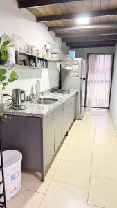 a kitchen with a refrigerator and a sink in it at Studio Jael Rivera in San Antonio