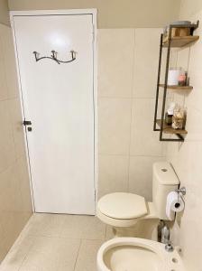 a bathroom with a toilet and a white door at Studio Jael Rivera in San Antonio