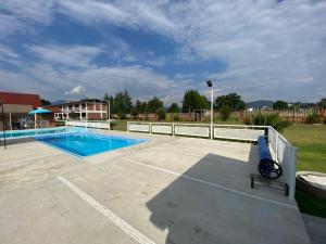 a large swimming pool with a fence around it at Hotel Ensueño del Bosque Valle de Bravo in Valle de Bravo