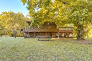 a large house with a picnic table in the yard at Secluded White River Haven! 4 Mi to Devil's Knob in Melbourne