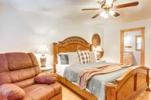 a bedroom with a bed and a leather chair at Secluded White River Haven! 4 Mi to Devil's Knob in Melbourne