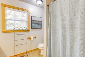 a bathroom with a toilet and a window at Secluded White River Haven! 4 Mi to Devil's Knob in Melbourne +28 photos