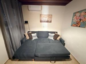 a living room with a couch in the corner of a room at GIANNIS HOUSE in Rhodes Town