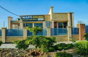 a building with a sign on the front of it at Nady Apartment in Dodoma
