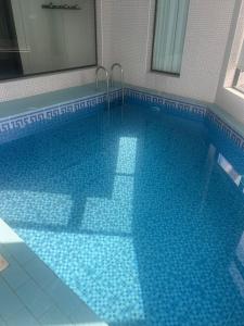 a swimming pool with a blue tile floor at شاليهات موج لاند 1 in Taif +2 photos