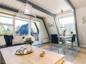 a living room with a table and a dining room at Himmerland Stay, Golf & Spa in Farsø