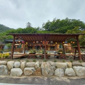 a pavilion with a picnic table and some rocks at Yangyang Haneul Cheon Ddaji in Yangyang +48 photos