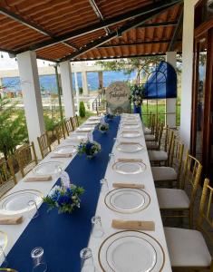 a long table with white plates and flowers on it at Mi Shalita in Santa Cruz