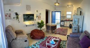 a living room with a couch and a refrigerator at Mountain View Chalet in Ras El Hekma ماونتن ڤيو رأس الحكمة in Ras Elhekma