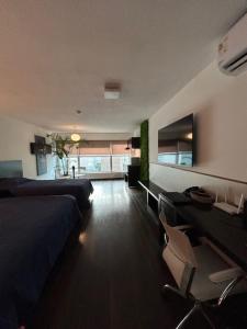 a bedroom with a bed and a desk and a couch at MySuites in Montevideo