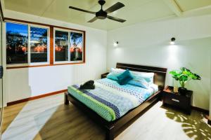 a bedroom with a bed with a cat laying on it at Wine Down in Agnes Water