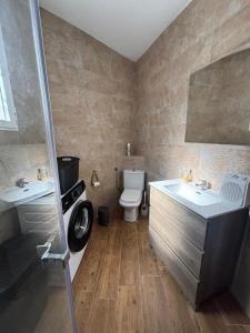 a bathroom with two sinks and a toilet at El Mirador de Espadan in Alcudia de Veo +21 photos