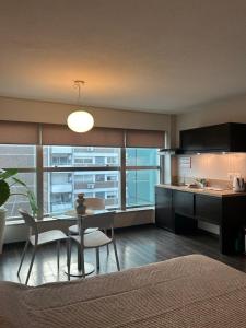 a kitchen and dining room with a table and chairs at MySuites in Montevideo