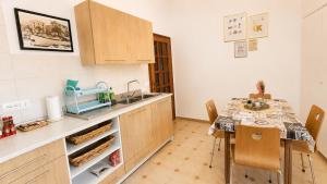 a kitchen with a sink and a table with chairs at Casa Garzoglio in Noli