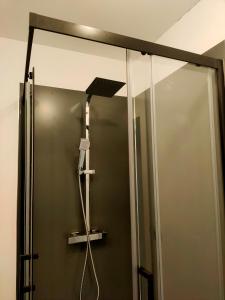 a shower in a bathroom with a mirror at La Maison bleue in Rossillon +61 photos